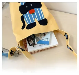 Interior view showing the large capacity of a yellow canvas bucket bag with cat print