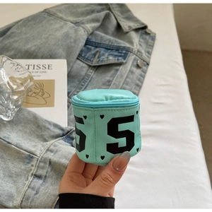 Close-up of mint green cylindrical mini pouch with number 5 print and zipper closure