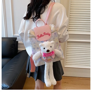 Detail of pink and white school backpack with cute plush bear and Hello Baby embroidery