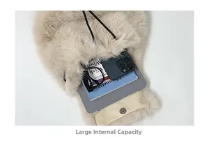 Internal view of beige plush backpack showing large capacity for books and phone