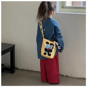Kids yellow canvas bucket bag featuring cute cartoon cat print and wide shoulder strap