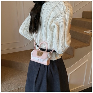Pink mini crossbody bag featuring brown bear embroidery, white lace trim and PU leather strap
