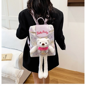 Detail of white printed backpack with purple leather flap and cute plush bear accessory