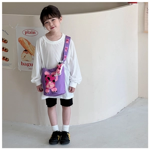 Toddler purple bucket bag with cute cat print and plush charm shown on model