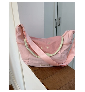 Detail of the pink nylon crescent bag featuring watermelon slice design and Guava text