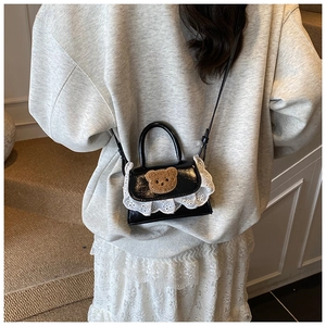 Mini black glossy crossbody bag with cute teddy bear plush patch and white lace trim