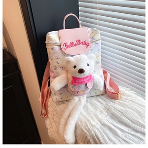 Detail of cute pink and cream backpack with plush bear and Hello Baby embroidery