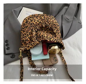 Detail view of leopard print crossbody bag showing large internal capacity and soft fabric