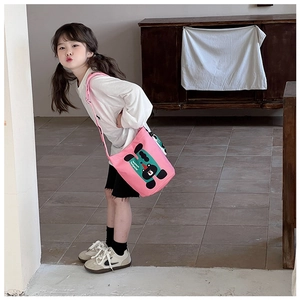 Pink canvas crossbody bag for children featuring cute cartoon prints and adjustable strap