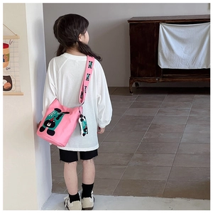 Pink canvas bucket bag for kids with printed wide strap and cute cartoon bear charm