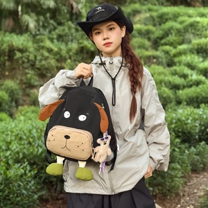 Creative puppy-shaped backpack with green paws and a cute plush bear pendant accessory