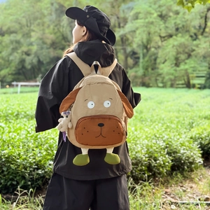 Creative puppy-shaped khaki backpack with 3D ears and feet shown in an outdoor setting