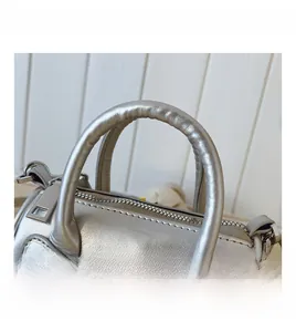 Silver metallic Boston bag with 3D bow design and reinforced comfortable top handles
