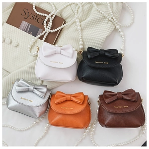 Detail of mini leather bags with bow knots and pearl straps in five assorted colors