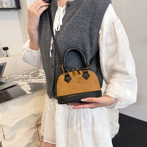 Mini quilted shell handbag in brown suede and black leather with gold zipper
