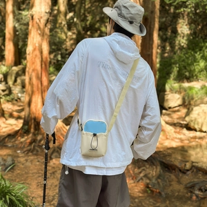 Outdoor lightweight crossbody bag with drawstring closure and contrasting blue flap detail