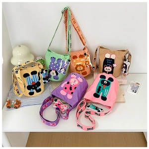 Collection of colorful cartoon animal canvas bucket bags with character charms for children