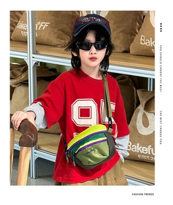 Detail of colorful patchwork nylon kids crossbody bag with adjustable black strap