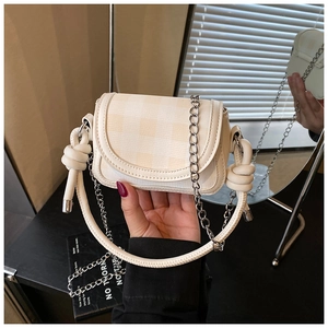 Detail of checkered cream mini bag with silver chain strap and knotted top handle