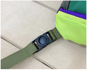Close-up of durable nylon webbing with a black plastic buckle on a kids mini bag