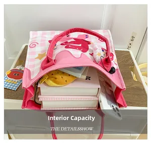 Interior view showing the large storage capacity of the pink checkered cartoon rabbit bag