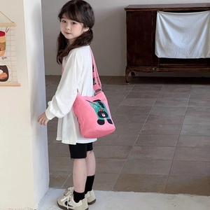 Pink canvas kids bucket bag featuring a cute cartoon bear print and wide shoulder strap