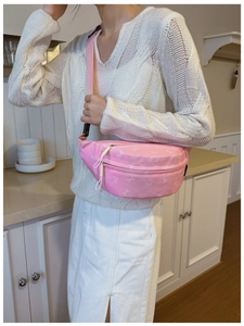 Detailed shot of pink kids waist bag with bow print and adjustable nylon strap