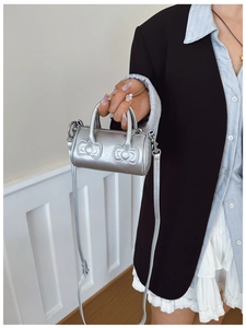 Silver mini barrel bag for girls with bow quilting and adjustable crossbody strap