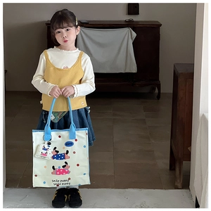 Close-up of kids canvas tote bag with cartoon puppy print and matching mini coin purse