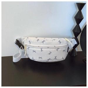 Detail of white kids chest bag with blue bow print and adjustable nylon strap design