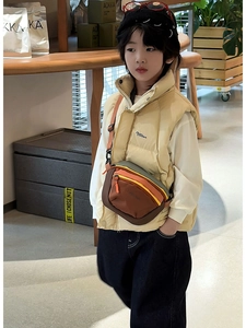 Kids colorful outdoor crossbody bag with adjustable strap worn by child in puffer vest