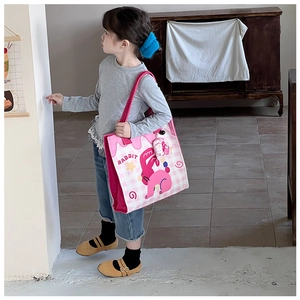 Detailed view of kids tote bag featuring pink checkered pattern and cute rabbit graphic