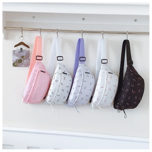 Detailed row of kids' bow-print waist bags in pink, white, purple, blue, and black
