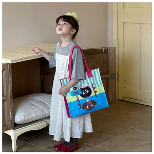 Detail of colorful striped canvas kids bag featuring cute cartoon cat and dog illustrations