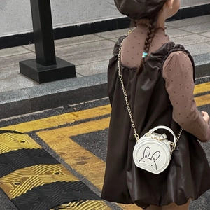 Detailed view of kids mini round leather crossbody bag with cartoon bunny and gold chain