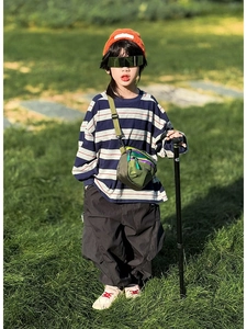 Outdoor shot of kids colorful dopamine mini crossbody bag with multi-pocket army green design