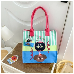 Detail of cute canvas tote bag featuring cartoon cat and dog with striped pattern