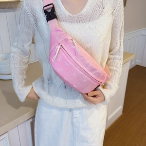 Pink crossbody waist bag for kids with cute white bow print and adjustable strap
