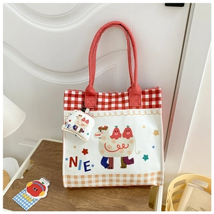 Detail of canvas tote bag with red checkered pattern and cartoon camel print illustration