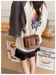 Brown retro PU leather messenger bag for kids with dual buckle straps and adjustable strap