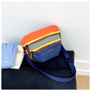 Detail of colorful nylon kids crossbody bag with orange zipper and blue adjustable strap