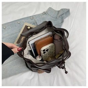 Spacious interior of brown leopard print drawstring backpack showing daily essentials