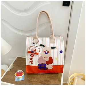 Detail of canvas tote bag and mini pouch with cute cartoon rabbit and pink stripes