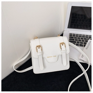 Detail of a white faux leather crossbody bag for kids with vintage buckles and fashion text