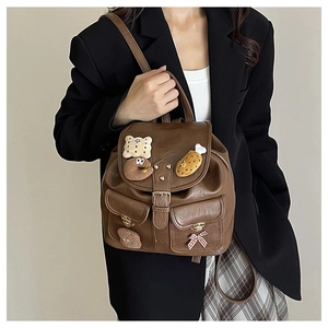 Close-up of retro brown backpack with cute food patches and multi-pocket design detail