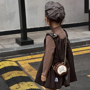Toddler girl in vintage brown dress with a mini round rabbit chain crossbody bag