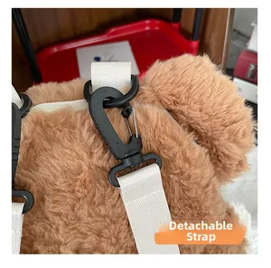 Detail of detachable strap and black plastic hook on brown plush bear backpack