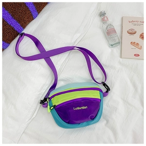 Detail of colorful nylon crossbody bag featuring multi-layer zippers and adjustable strap