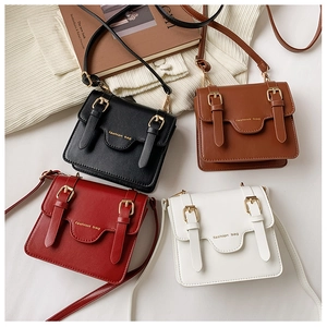 Collection of vintage kids messenger bags in black, brown, red, and ivory white colors