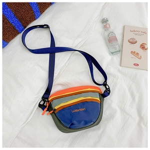 Detail of colorful patchwork nylon kids crossbody bag with adjustable strap and embroidery